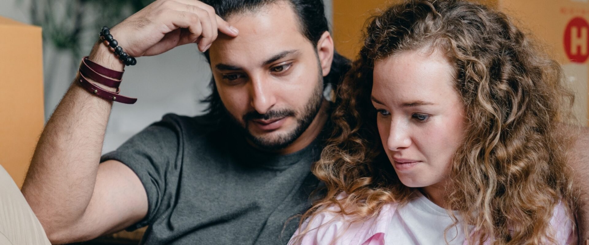 Woman and man sitting together looking at a mobile phone.