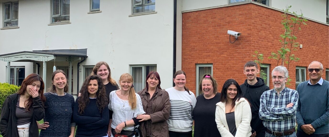 A group of Response colleagues smiling and standing outside one of our services.
