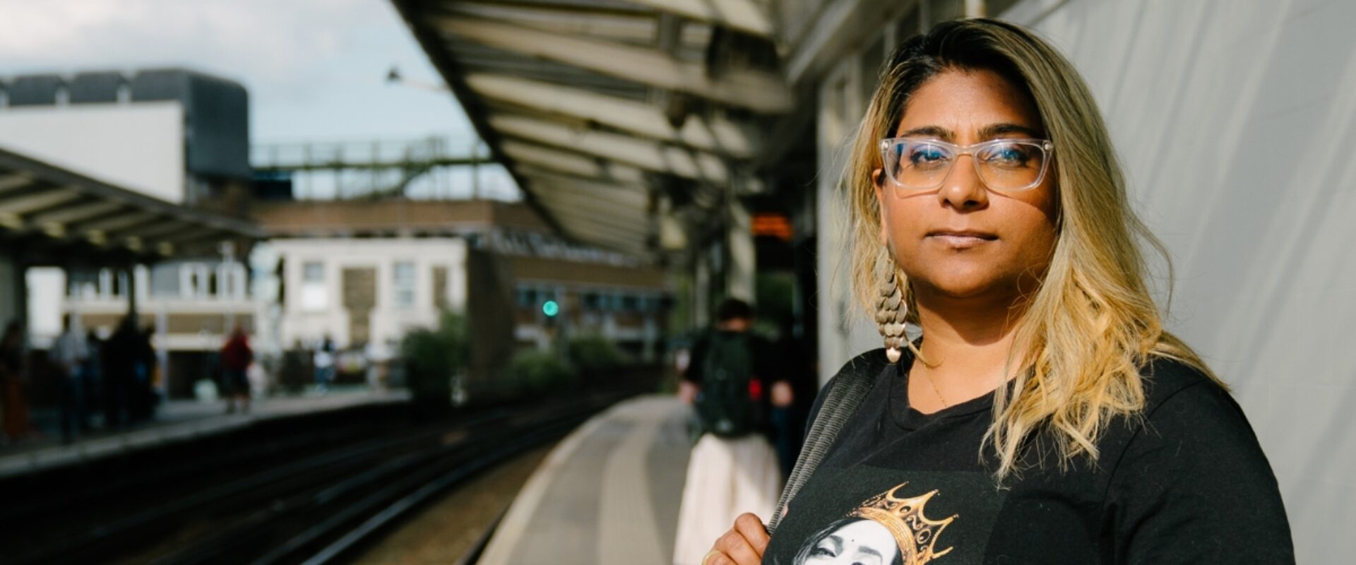 Woman at train station smiling