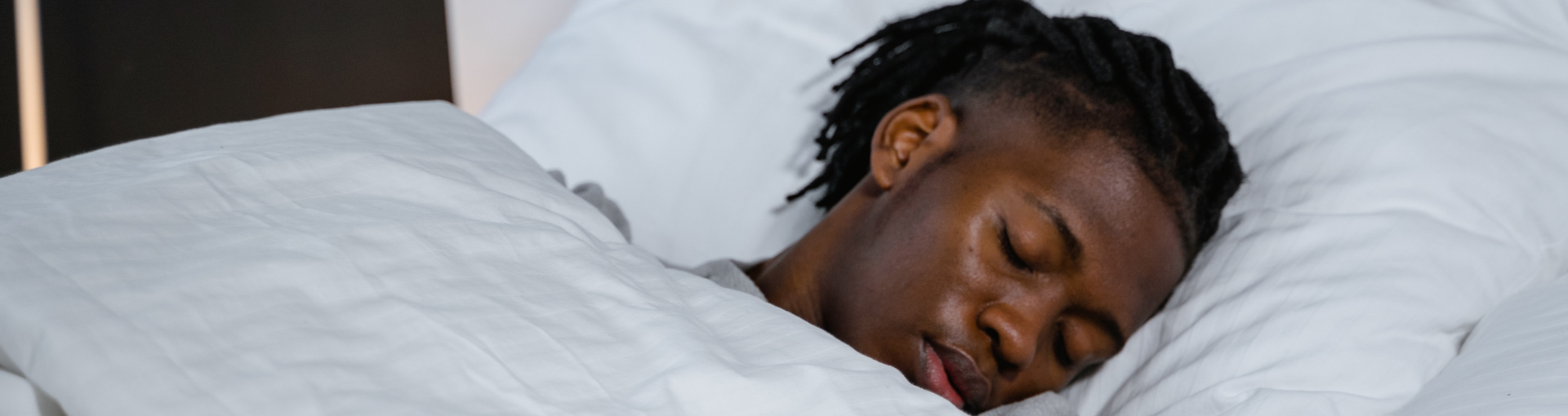 Image of a man asleep in bed.