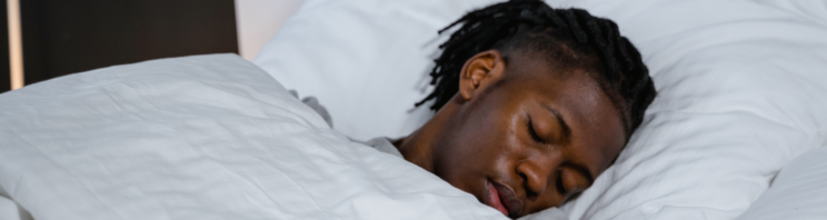 Image of a man asleep in bed.
