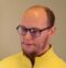 Photo of Response resident, Patrick, in yellow top and glasses.